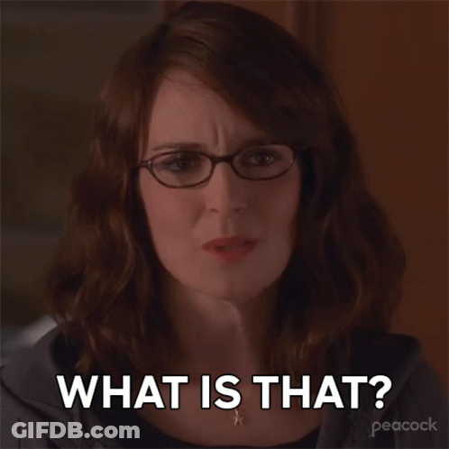 A Woman Wearing Glasses And A Necklace Says What Is That GIF
