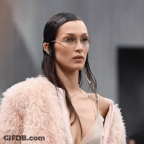 A Woman Wearing Glasses And A Pink Fur Coat GIF
