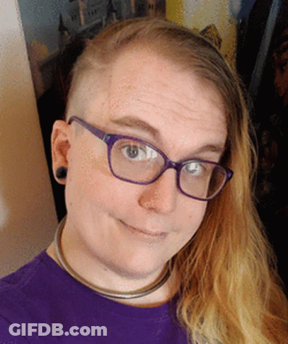 A Woman Wearing Glasses And A Purple Shirt GIF