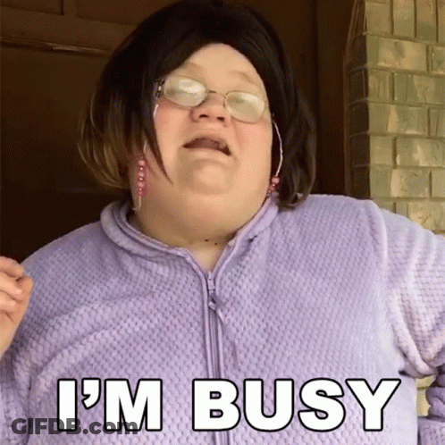 A Woman Wearing Glasses And A Purple Sweater Says I 'M Busy GIF