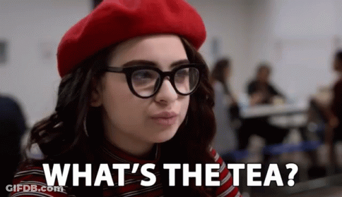 A Woman Wearing Glasses And A Red Beret Is Asking What 'S The Tea GIF