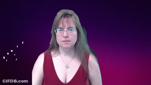 A Woman Wearing Glasses And A Red Tank Top Has A Butterfly Necklace GIF