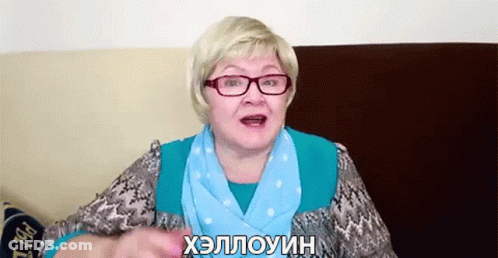 A Woman Wearing Glasses And A Scarf Is Talking In Russian GIF