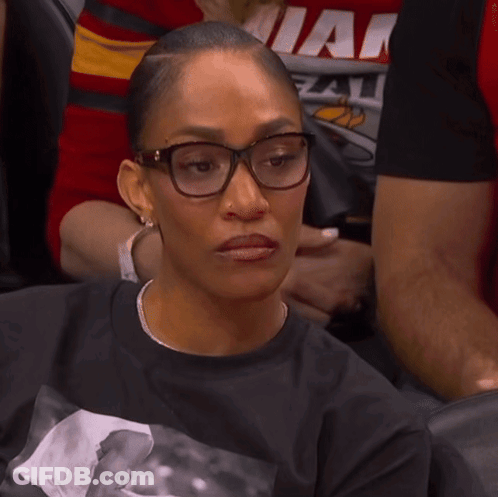 A Woman Wearing Glasses And A Shirt That Says Miami GIF