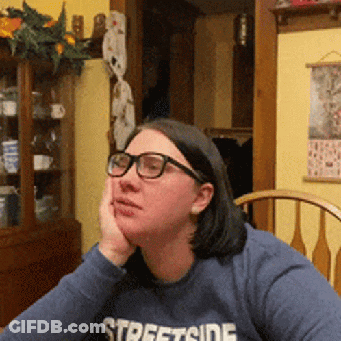 A Woman Wearing Glasses And A Streetside Sweatshirt GIF