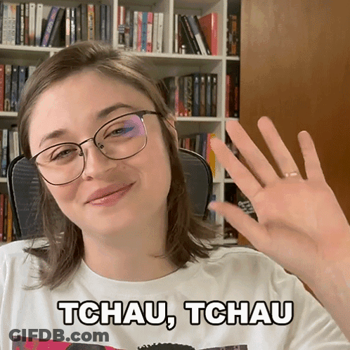 A Woman Wearing Glasses And A Tchau Tchau Shirt GIF
