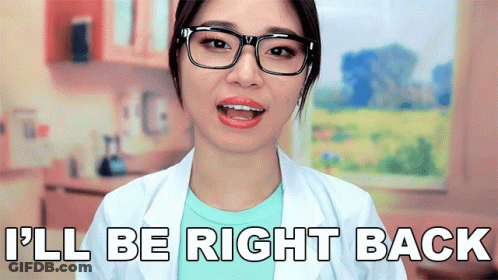 A Woman Wearing Glasses And A White Lab Coat Says I 'Ll Be Right Back GIF