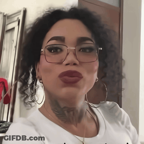 A Woman Wearing Glasses And A White Shirt Has A Tattoo On Her Neck That Says " I Love You " GIF