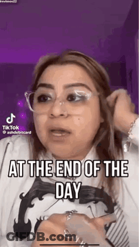 A Woman Wearing Glasses And A White Shirt Is Talking On A Tiktok Video . GIF