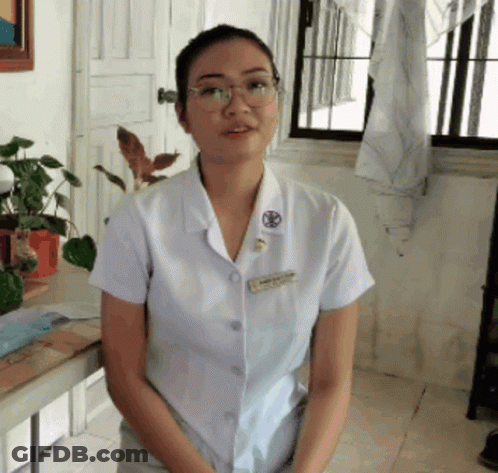 A Woman Wearing Glasses And A White Shirt With A Name Tag That Says ' Nurse ' On It GIF