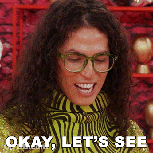 A Woman Wearing Glasses And A Zebra Print Sweater Says " Okay Let 'S See " GIF