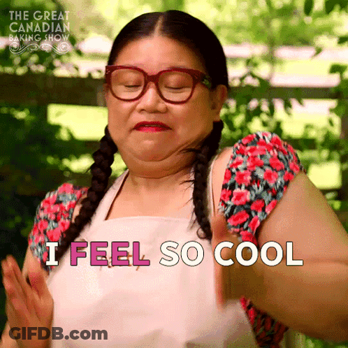 A Woman Wearing Glasses And An Apron Is Saying I Feel So Cool GIF