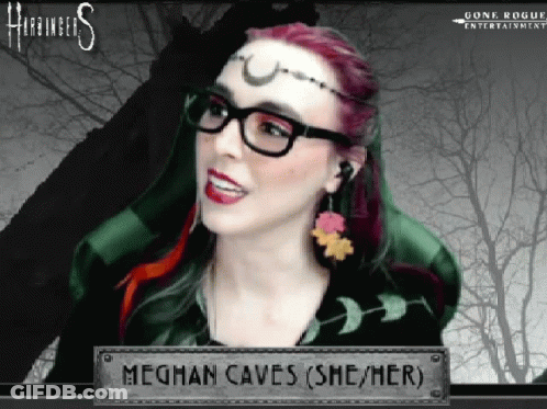 A Woman Wearing Glasses And Earrings Is Named Meghan Caves ( She / Her ) GIF
