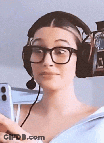 A Woman Wearing Glasses And Headphones Is Holding A Cell Phone GIF