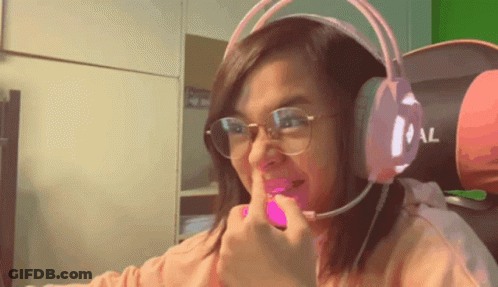 A Woman Wearing Glasses And Headphones Is Making A Face GIF