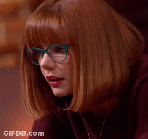 A Woman Wearing Glasses And Red Lipstick Says Le Gasp . GIF
