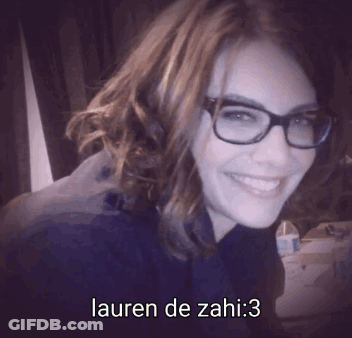 A Woman Wearing Glasses And Smiling With Lauren De Zahi : 3 Written Below Her GIF