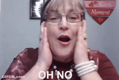 A Woman Wearing Glasses Holds Her Hands To Her Face And Says " Oh No " GIF