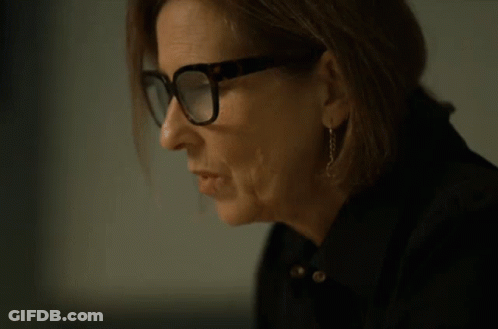 A Woman Wearing Glasses Is Drinking From A Can Of Soda GIF