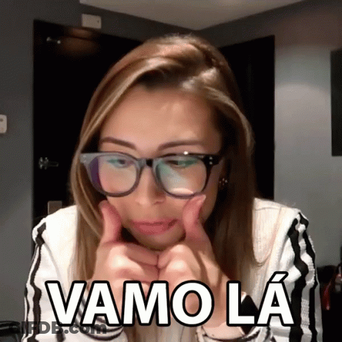 A Woman Wearing Glasses Is Giving A Thumbs Up And Says Vamo La In White Letters GIF