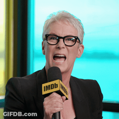 Woman With Glasses Holding IMDb Microphone GIF