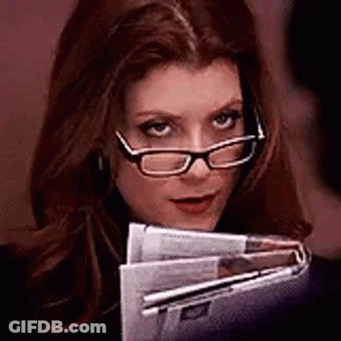 Woman Wearing Glasses Holding Newspapers GIF