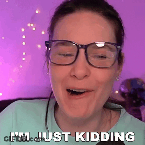 A Woman Wearing Glasses Is Making A Funny Face And Says I 'M Just Kidding GIF