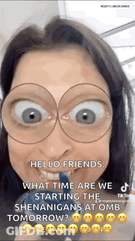 A Woman Wearing Glasses Is Making A Funny Face While Holding A Toothbrush . GIF