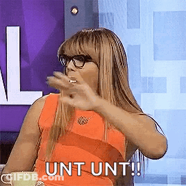 A Woman Wearing Glasses Is Sitting At A Table With A Cup Of Coffee . GIF