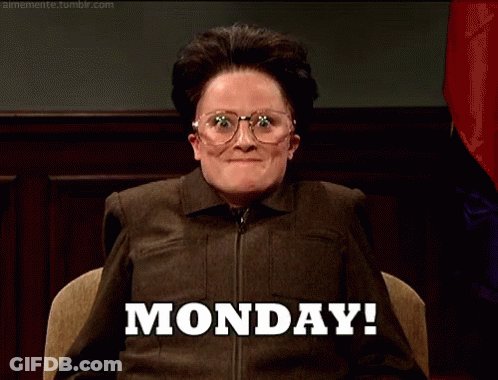 A Woman Wearing Glasses Is Sitting In Front Of A Sign That Says Monday . GIF