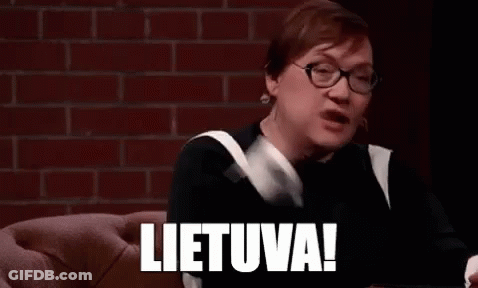 A Woman Wearing Glasses Is Sitting On A Couch With Her Hands In The Air And The Word Lietuva Written On Her Face . GIF