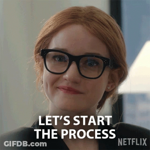 A Woman Wearing Glasses Is Smiling And Says Let 'S Start The Process GIF