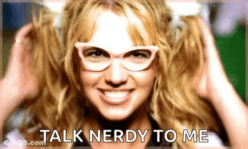 A Woman Wearing Glasses Is Smiling And Says Talk Nerdy To Me GIF