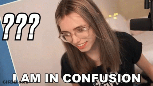 A Woman Wearing Glasses Is Smiling In Front Of A Microphone With The Words I Am In Confusion Below Her GIF