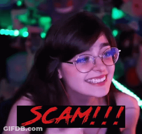 A Woman Wearing Glasses Is Smiling With The Words Scam !!! Below Her GIF