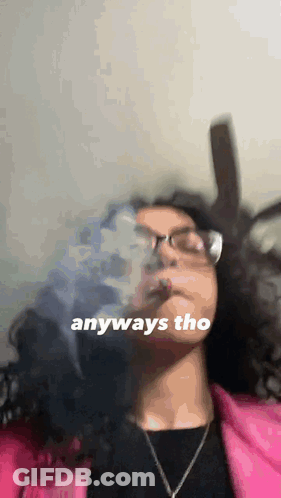 A Woman Wearing Glasses Is Smoking A Cigarette With The Words Anyways Tho Written On The Bottom . GIF