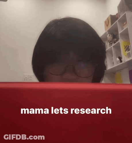 A Woman Wearing Glasses Looks At A Red Box That Says Mama Lets Research On It GIF