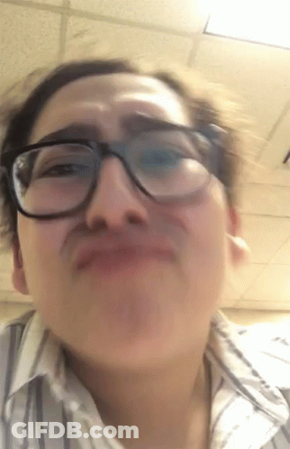 A Woman Wearing Glasses Making A Funny Face GIF