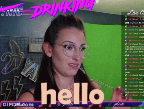 A Woman Wearing Glasses Says Hello In Front Of A Screen That Says Drinking GIF