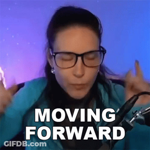 A Woman Wearing Glasses Says Moving Forward In Front Of A Microphone . GIF