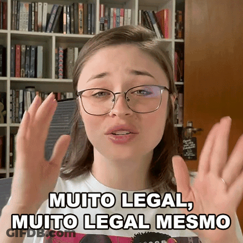 A Woman Wearing Glasses Says Muito Legal Muito Legal Mesmo In Front Of A Bookshelf GIF