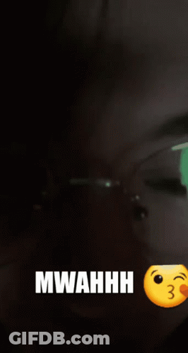 A Woman Wearing Glasses Says Mwahhh Next To A Kissing Smiley Face GIF