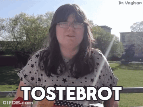 Woman With Glasses Says Tostebrot In Grass Field GIF