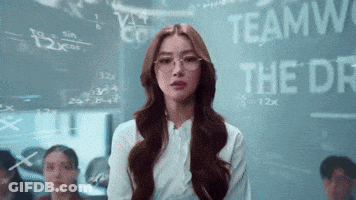A Woman Wearing Glasses Stands In Front Of A Blackboard That Says Teamwork GIF