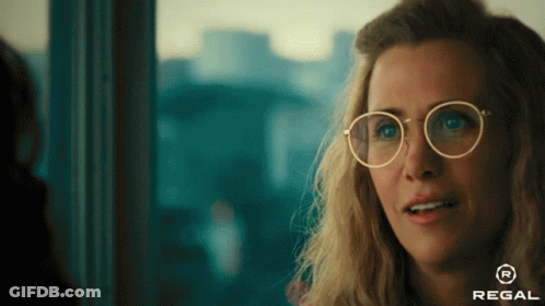A Woman Wearing Glasses With A Regal Logo On The Bottom GIF