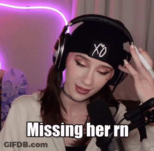 A Woman Wearing Headphones And A Beanie Is Missing Her Rn GIF