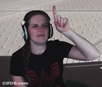 A Woman Wearing Headphones And A Black Shirt With The Letter M On It GIF