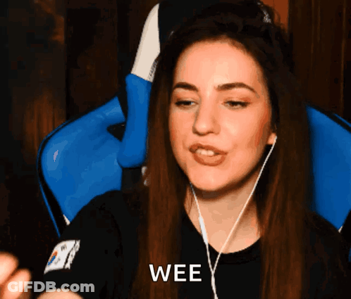 A Woman Wearing Headphones And A Black Shirt With The Word Wee On It GIF