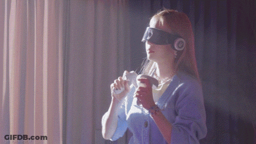 A Woman Wearing Headphones And A Blindfold Is Holding A Remote Control GIF