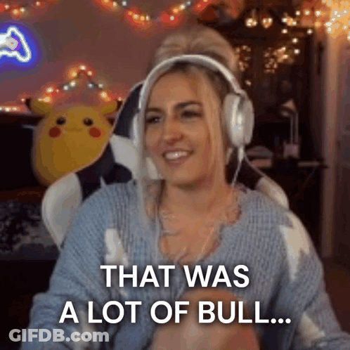 A Woman Wearing Headphones And A Blue Sweater Is Sitting In A Chair . GIF